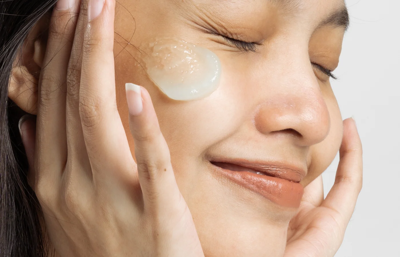 Close up woman with lightweight cream on her face - Moisturizers For Oily Skin