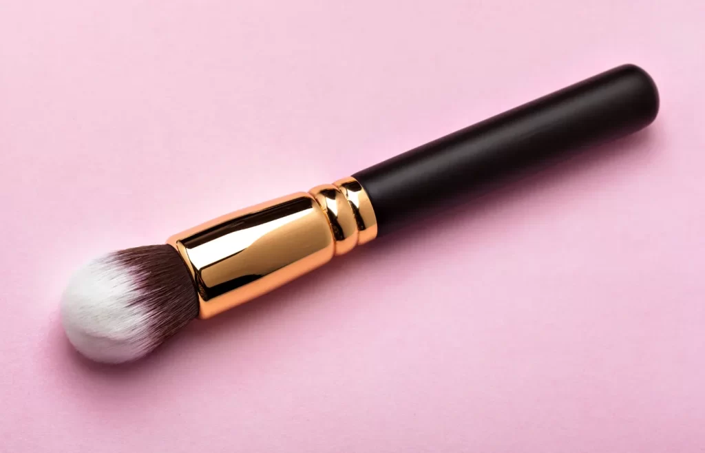 a foundation brush with a pink background - best makeup brushes for foundation