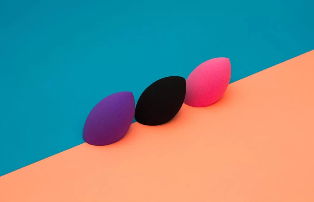 Purple, black, and pink makeup sponges - How to apply makeup on dry skin